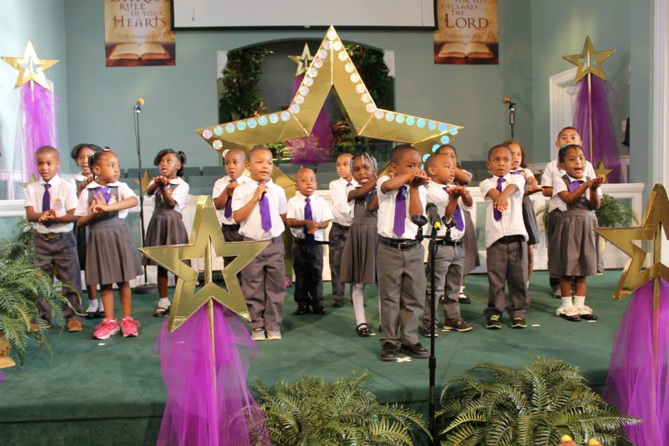 Jeremiah Dennis leading the audience is saying the "Pledge to the Bible"