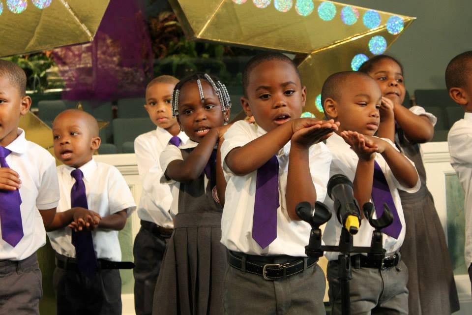 Jeremiah Dennis leading the audience is saying the "Pledge to the Bible"